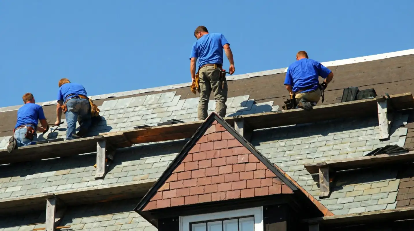 Roof replacement in progress with a team of professional contractors installing new shingles on a residential home in San Jose, CA