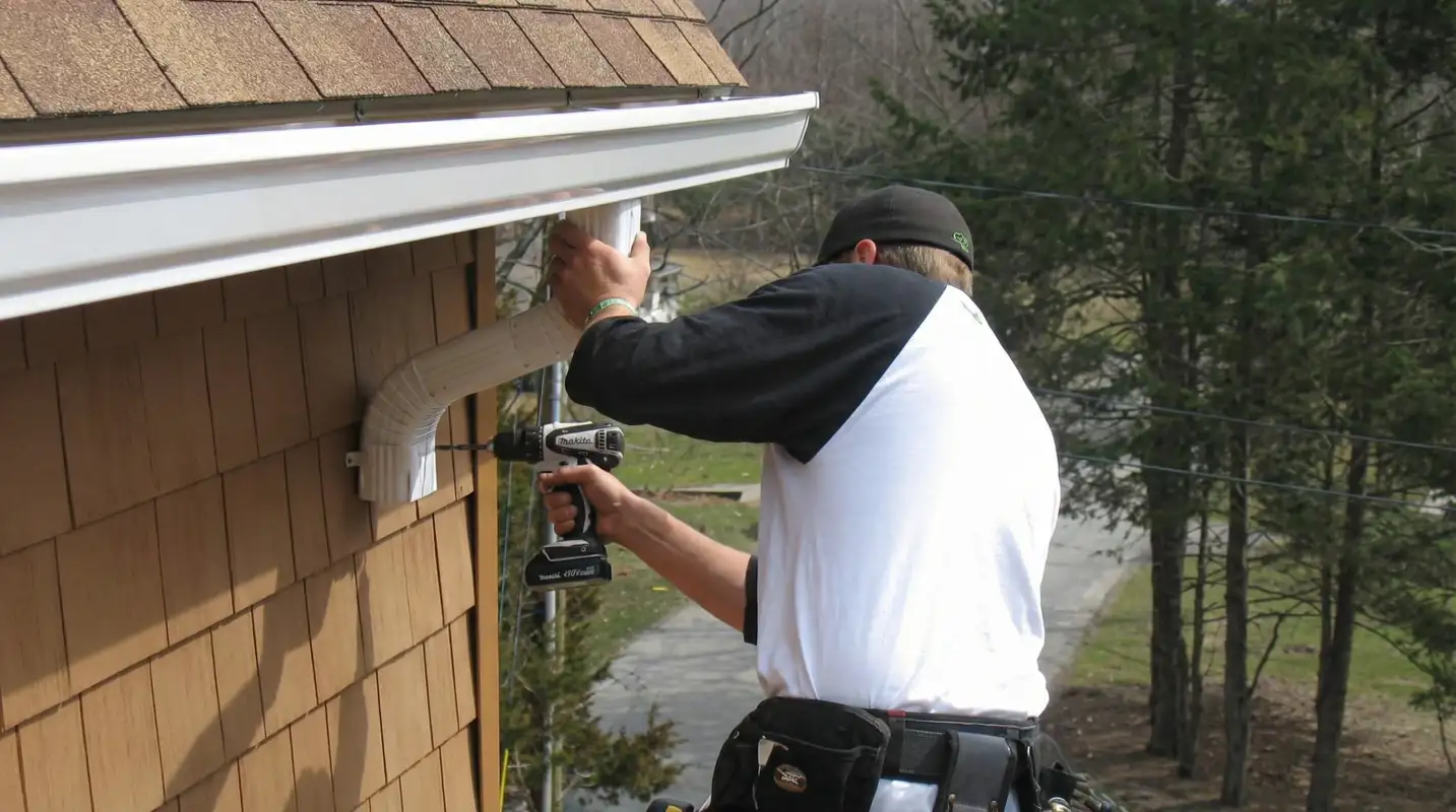 Professional contractor installing tan vinyl siding panels on a residential home exterior in San Jose, CA